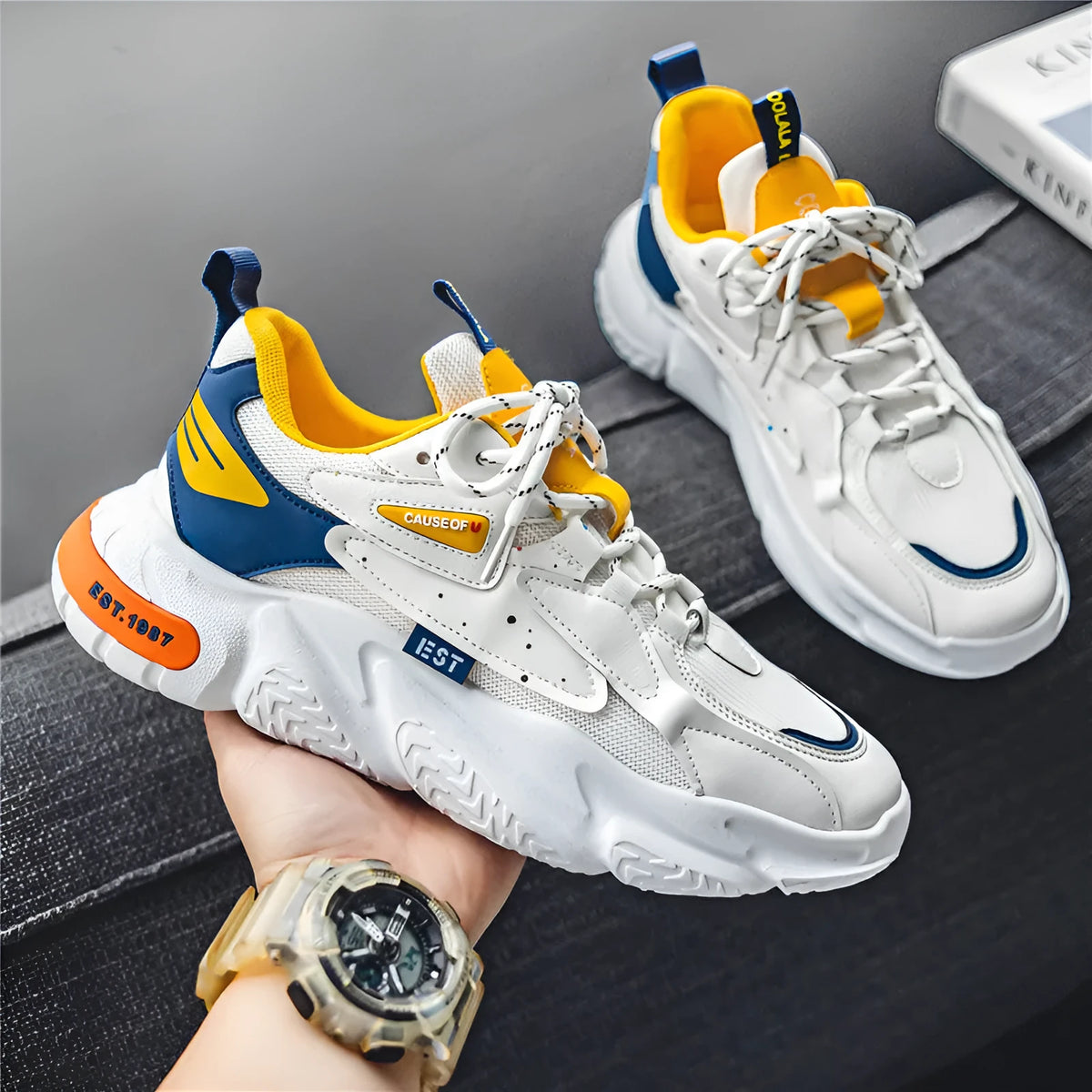 Men's low top casual pumps with 3-5cm mid heel, round toe, rubber sole, in white orange, white grey, or white blue.