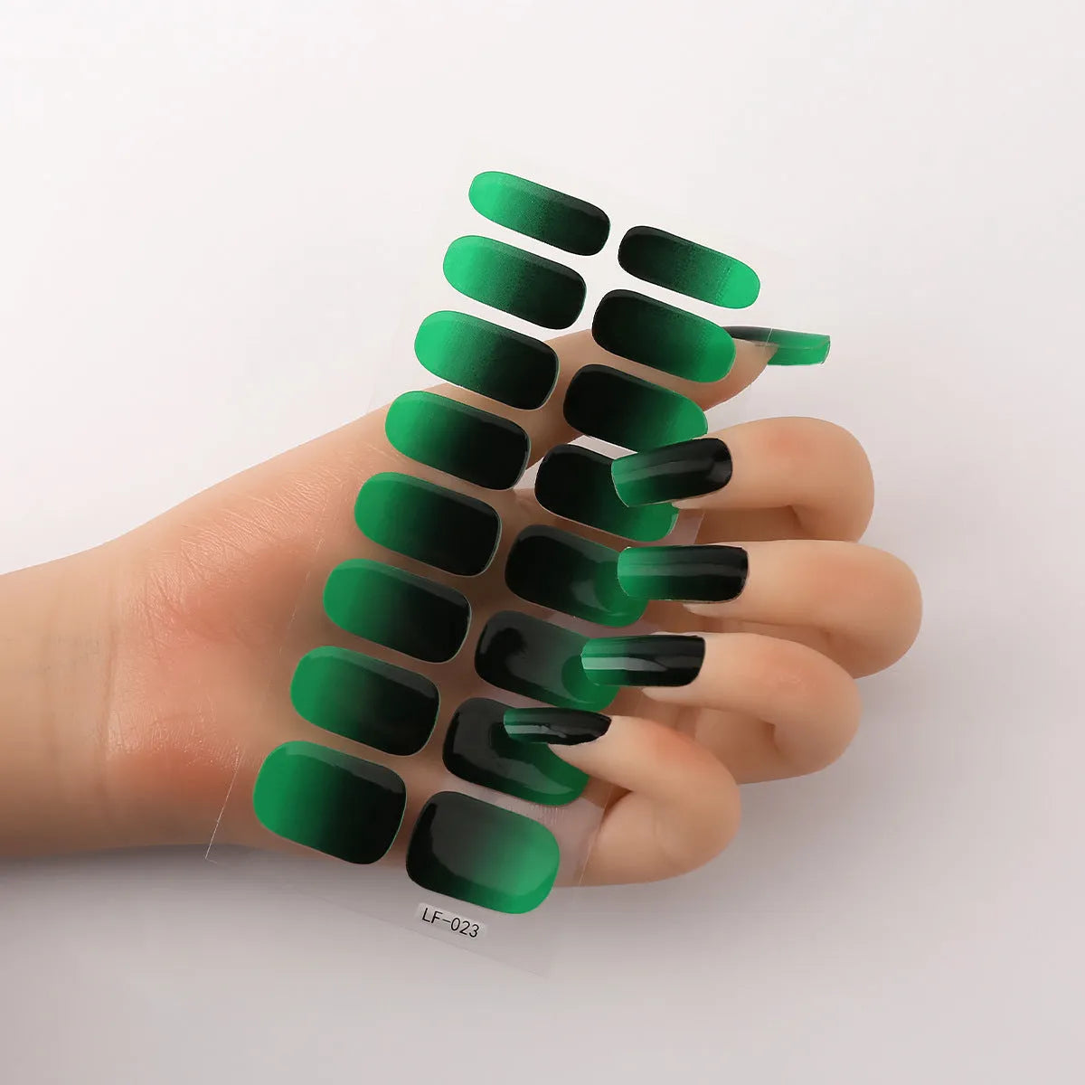 Sheet of 16 small design nail art stickers including cross, rose, tulip and marble patterns.