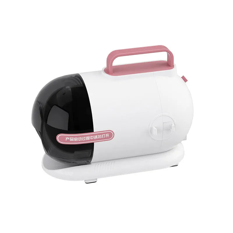 Pink and white pet grooming vacuum cleaner with shear attachment and accessories on a white background.