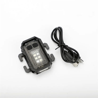 Compact black rechargeable tactical flashlight with USB charging cable for backpack mounting.