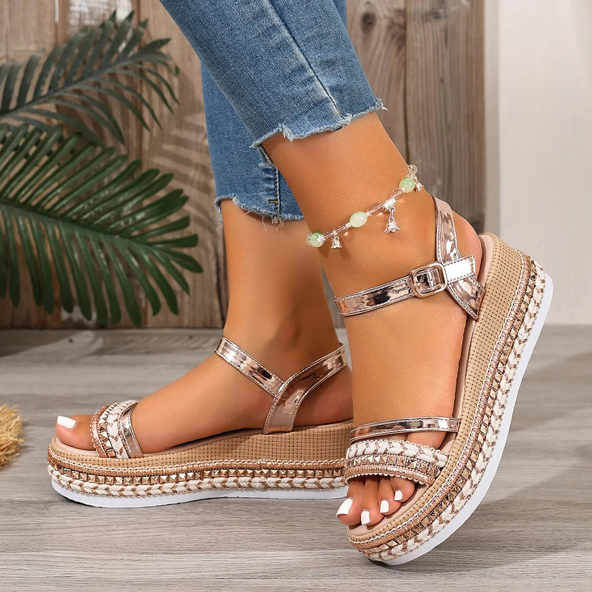 Gold-coloured women's wedge sandals with round toe and woven PU upper.