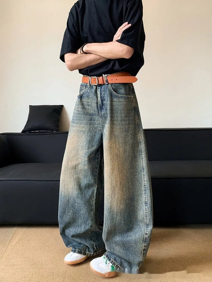 Man wearing retro blue distressed slim-fit jeans with a wide-leg cut.