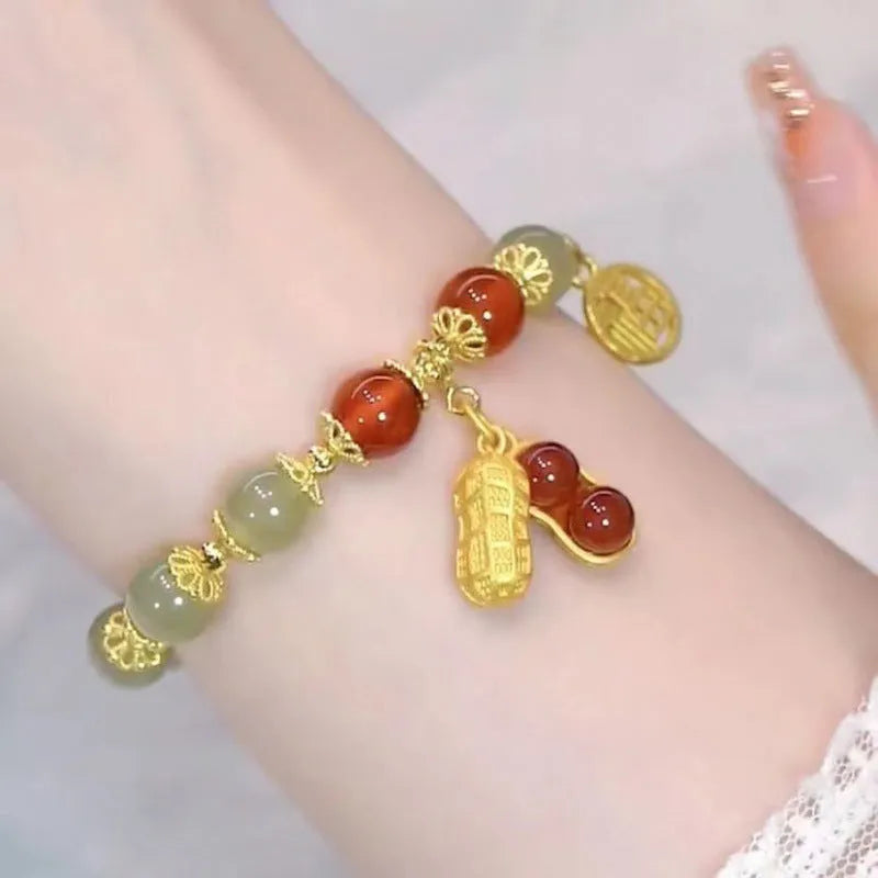 Chinese style glass bead bracelet with bamboo joint design on wrist.