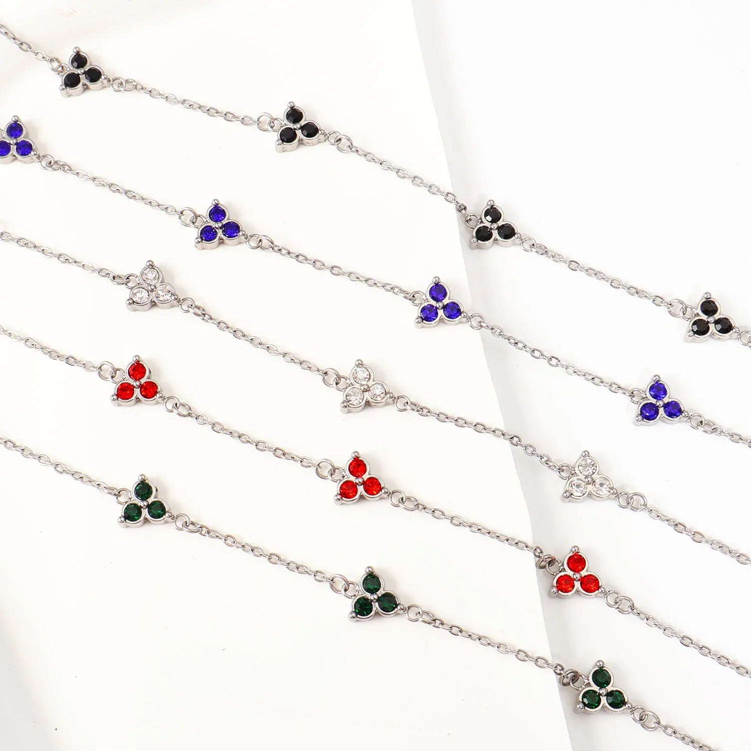 Women's stainless steel bracelet with three triangle-shaped charms in different coloured stone settings