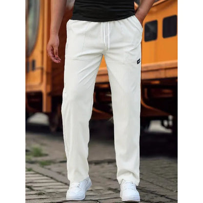 Men's polyester trousers for spring and autumn in light grey, shown in a casual setting