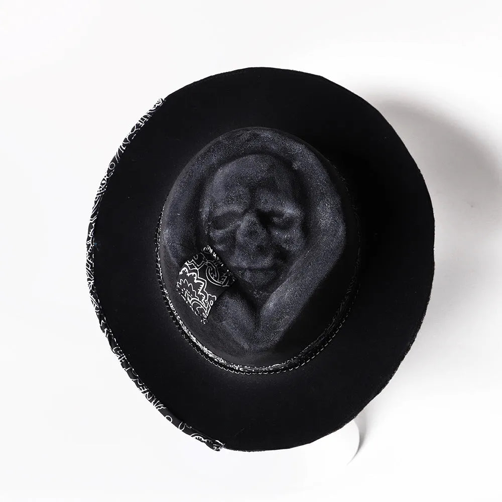 Handmade wool felt skull hat with conical crown design, showing textured surface and distinctive silhouette