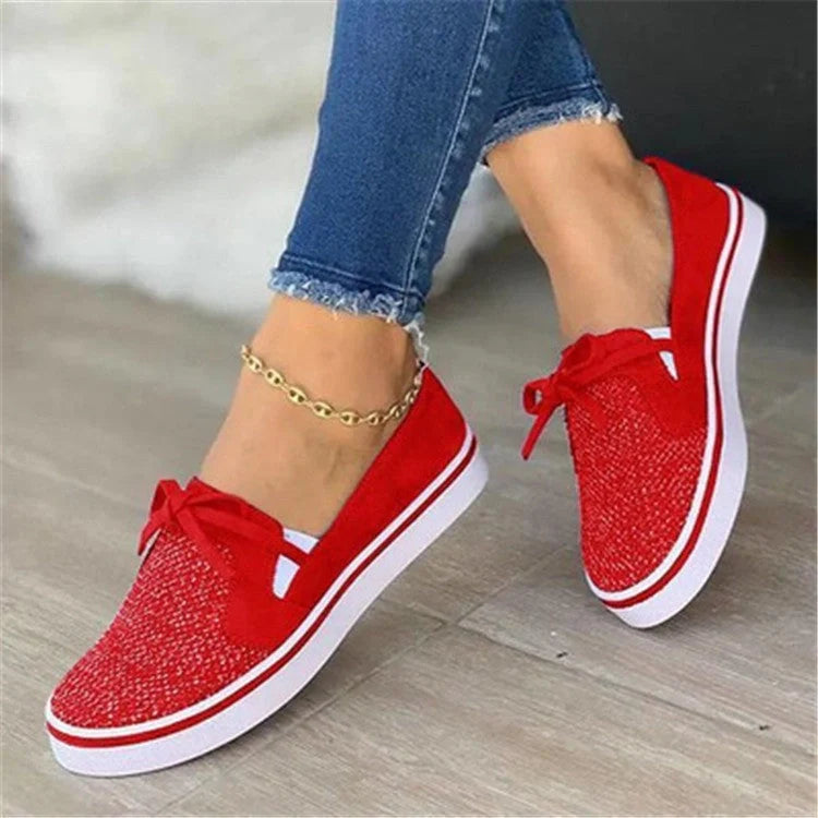 Women's white lace-up canvas flat sneakers with cross straps