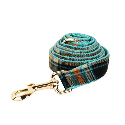 Green retro style cloth dog collar, lead, vest, and bow set displayed together.