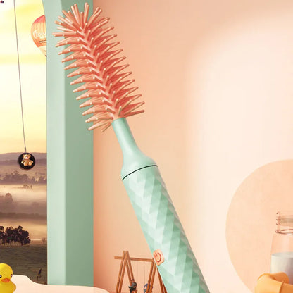 Electric baby bottle cleaning brush with rotating silicone head in pink or green colours