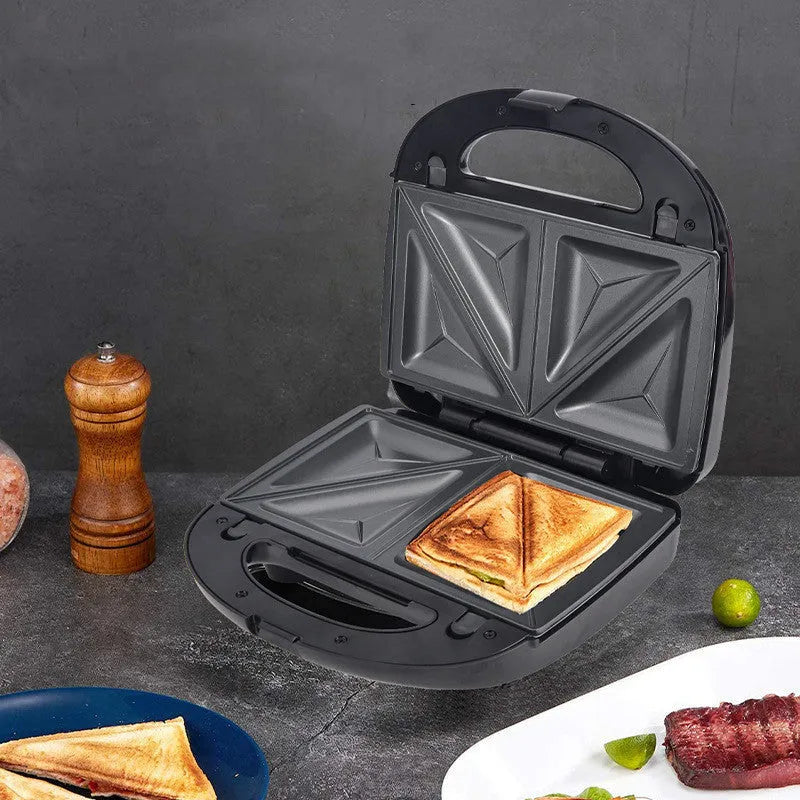 Black double-sided heating electric sandwich pan with brushed stainless steel top cover and non-stick coating.