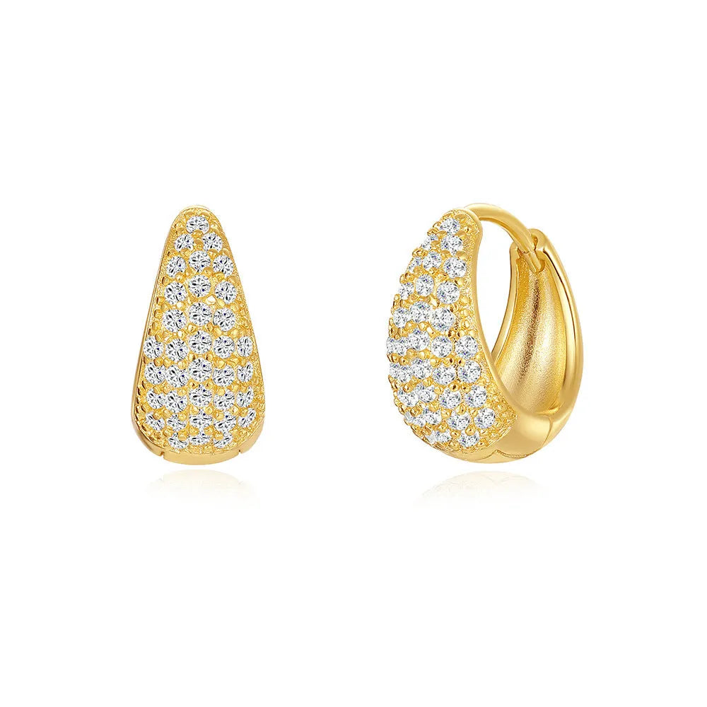 A pair of golden geometric clip-on earrings with a round design element on a white background.