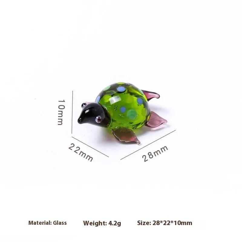 Geometric glass turtle figurine ornament on a desk, shown in blue head and blue shell colour variant.