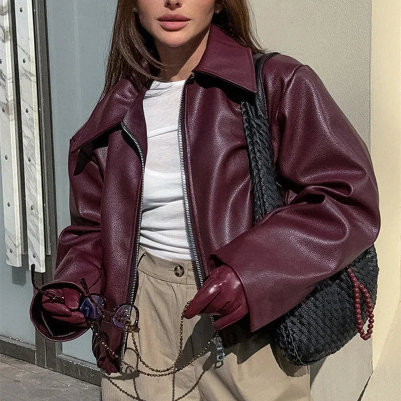 Stylish faux leather jacket with zip-up closure and lapel collar, available in burgundy and black colors