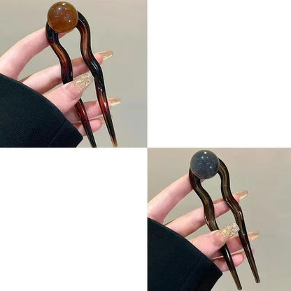 Acrylic U-shaped hair barrette with retro ball design in caramel colour