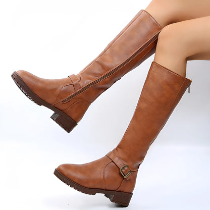 Women's black high knight boots with a square heel, round toe, and ankle buckle detail.