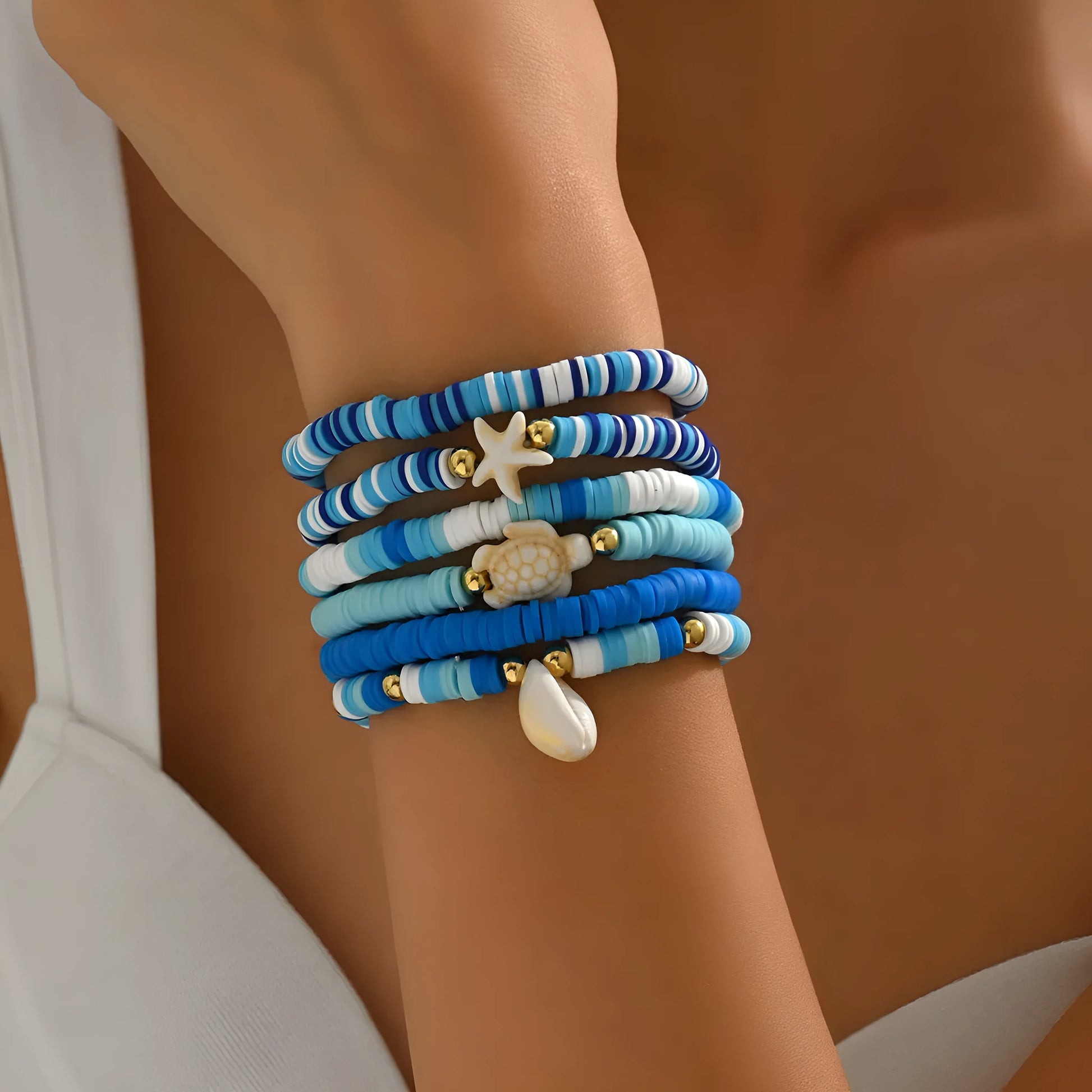 Six handmade polymer clay bracelets with geometric shell designs in bohemian blue colour