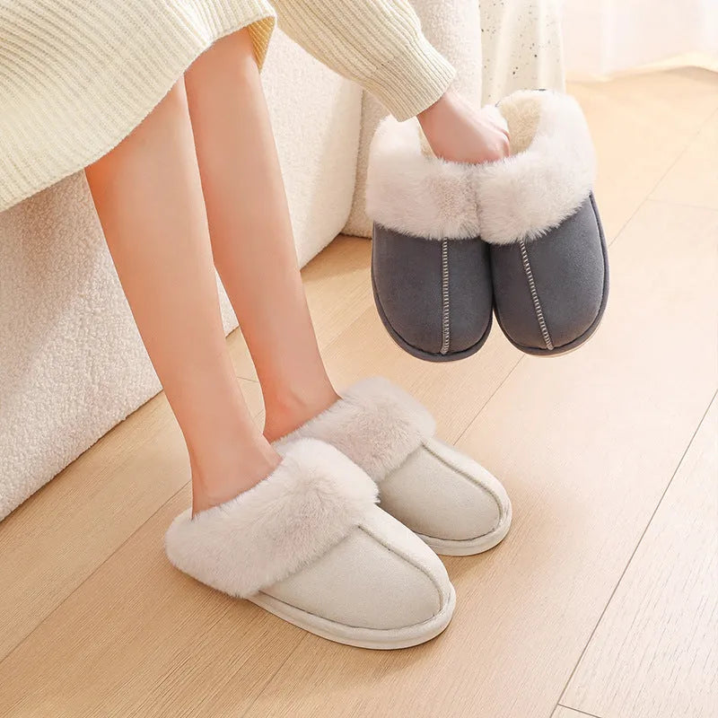 Women's plush indoor slippers in a selection of colours with a fuzzy upper and flat sole.