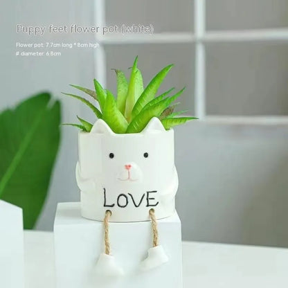 Ceramic hanging foot flowerpot for succulent plants with cartoon styling on desktop
