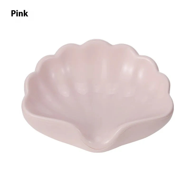 Plastic shell soap dish in pearl white, dimensions 12x9x5.5cm, on a bathroom counter