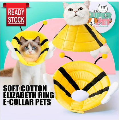 Soft fabric cat cone collar with cute bee design and Velcro closure on a table