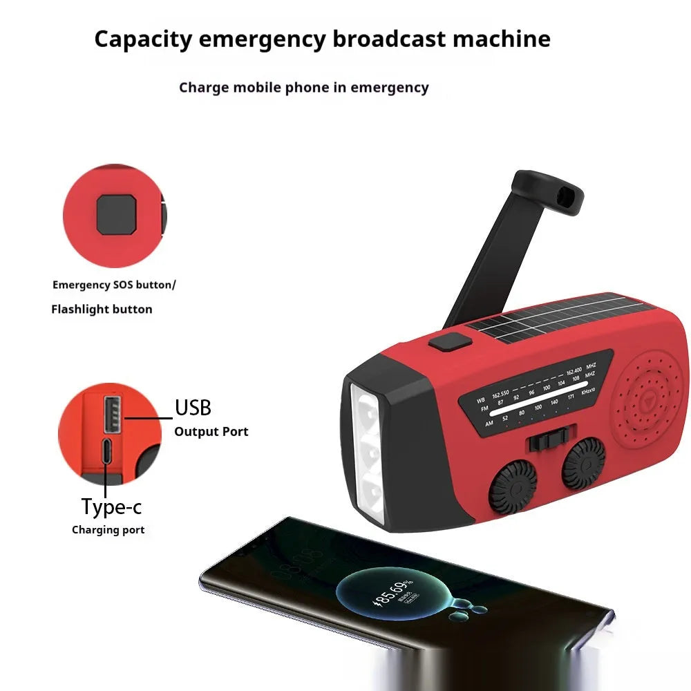 Red rechargeable hand radio with emergency torch, showing compact design with speaker grill and wrist strap attachment