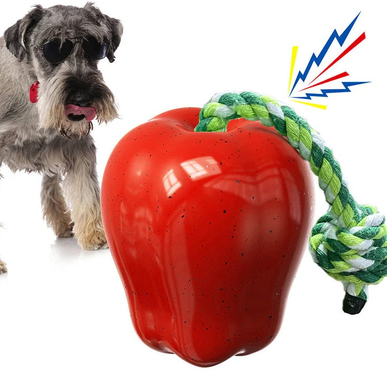 Green squeaky apple-shaped dog toy with treat-dispensing function, approximately 10-12cm diameter