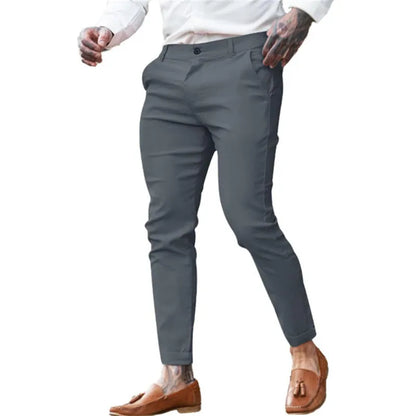 Men's slim fit elastic cotton pencil trousers in a solid colour on a hanger, showing the zip fly and mid waist design.