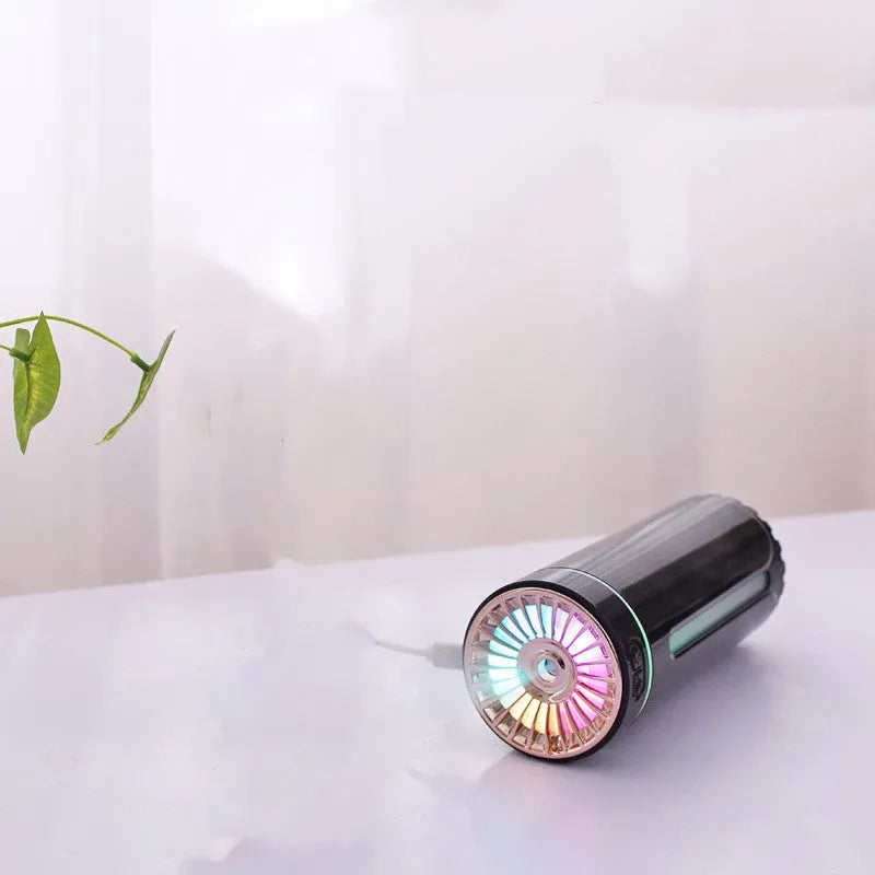 Black wireless car humidifier with colourful LED lights shown in vehicle cup holder