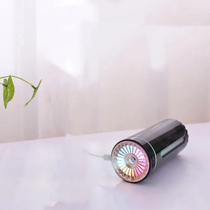 Black wireless car humidifier with colourful LED lights shown in vehicle cup holder