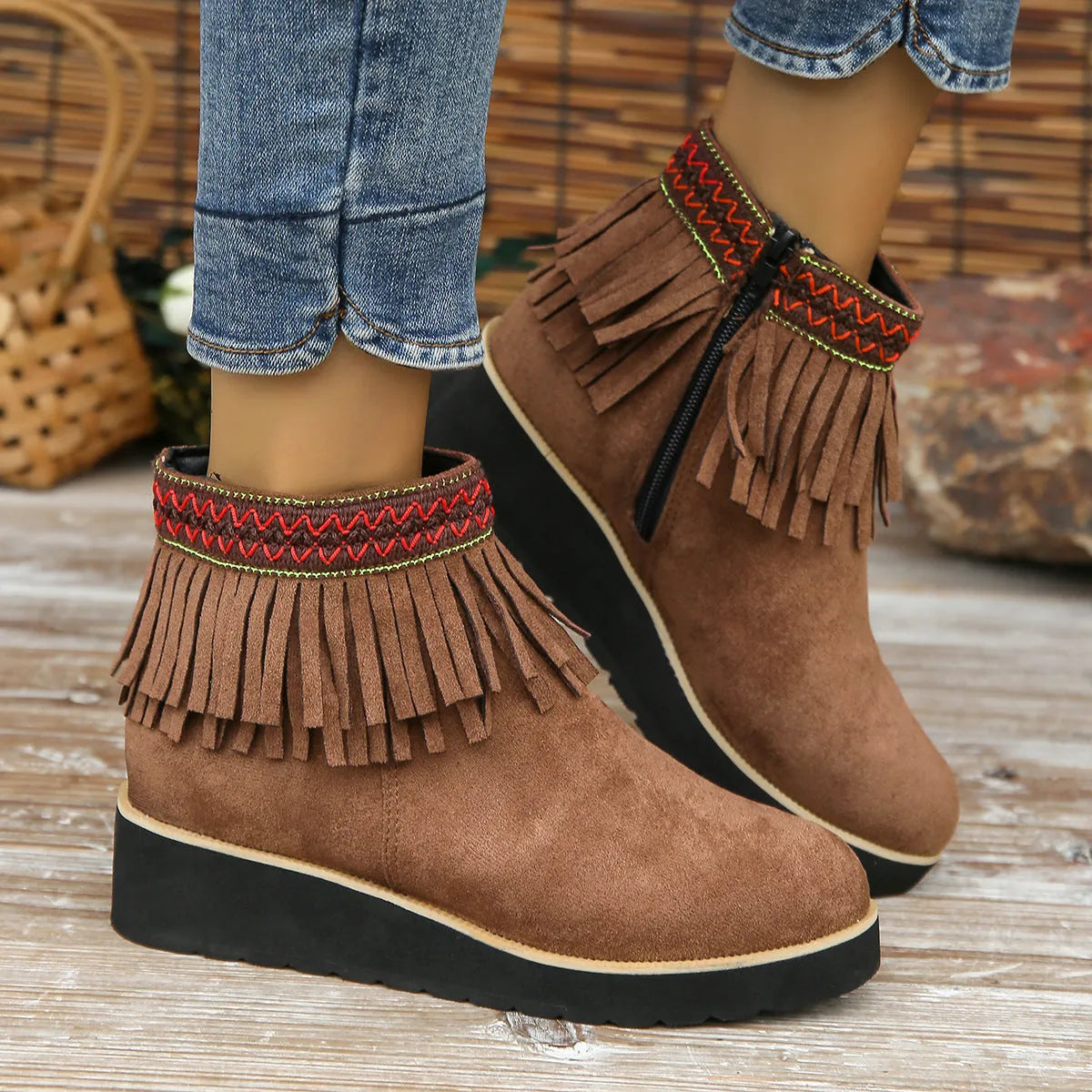 Women's thick bottom wedge bootie in suede with side zipper and tassel detail, available in multiple colours.