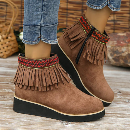Women's thick bottom wedge bootie in suede with side zipper and tassel detail, available in multiple colours.