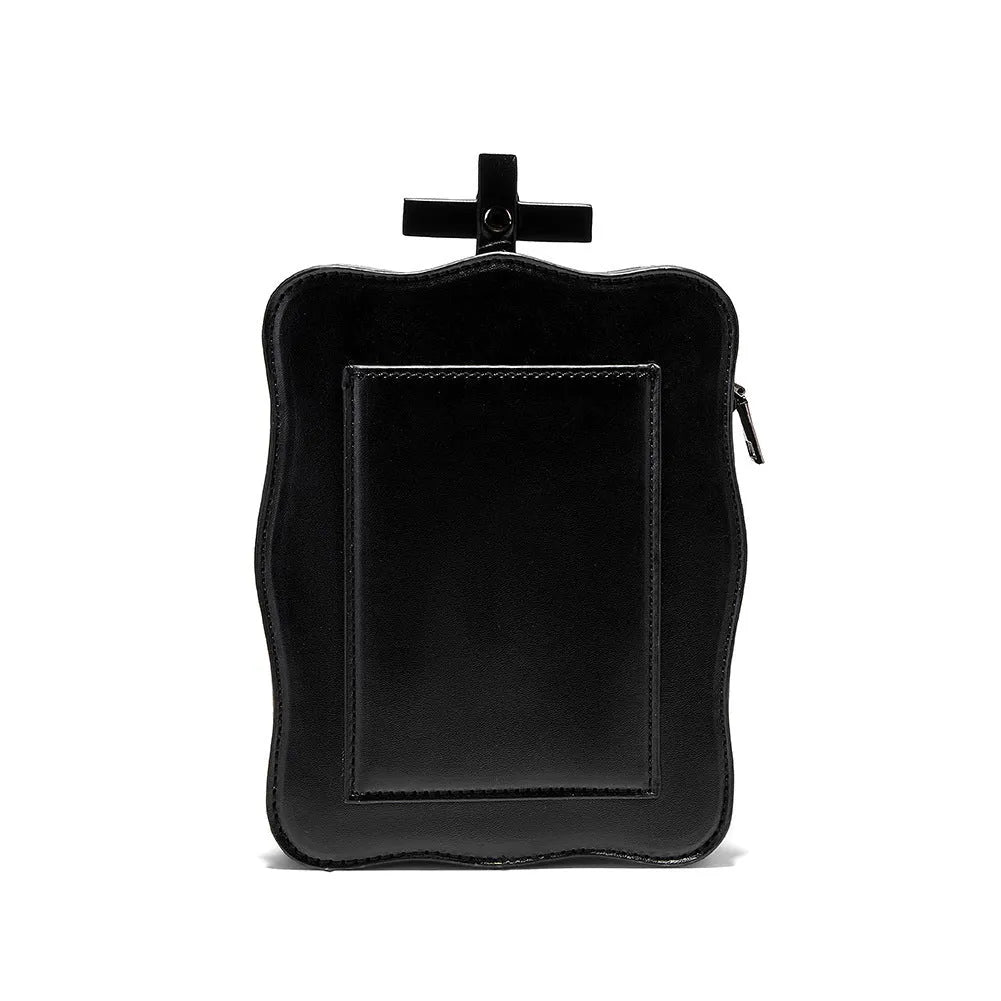 Black mini square messenger bag with embossed skull design, metal chains, and crossbody strap