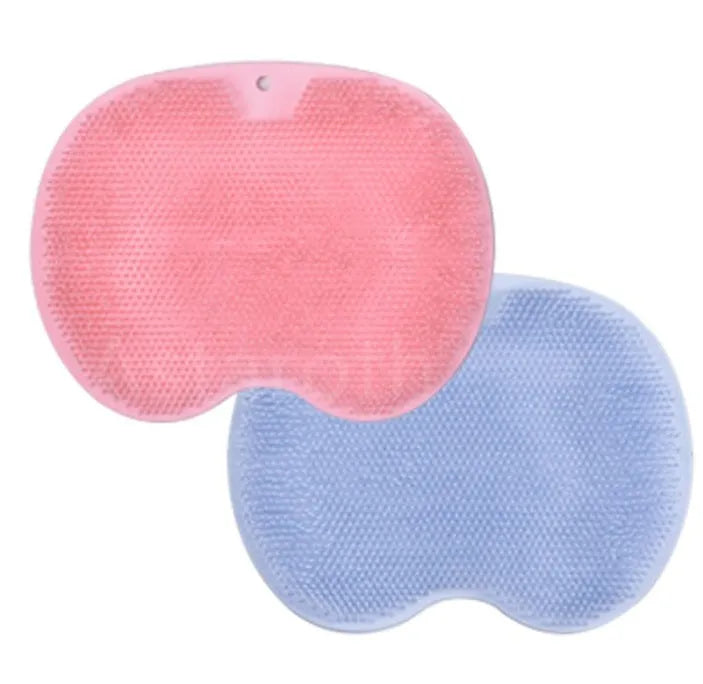 Orange non-slip massage bath brush with silicone bristles and suction cup base on shower floor