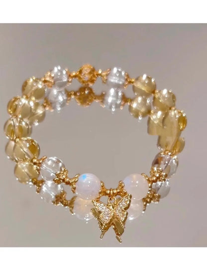 Chinese style white crystal beaded bracelet with citrine butterfly charm on adjustable string.