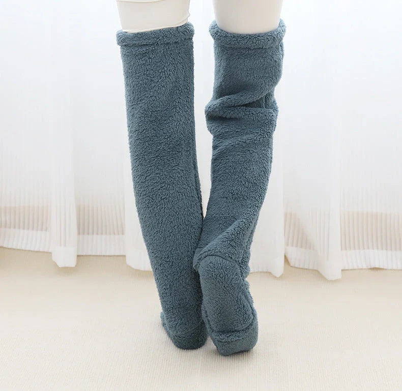 Cozy over-the-knee fuzzy socks in various colors, including brown, blue, dark gray, pink, silver, and more. Comfortable cotton design for warm, snug legs.