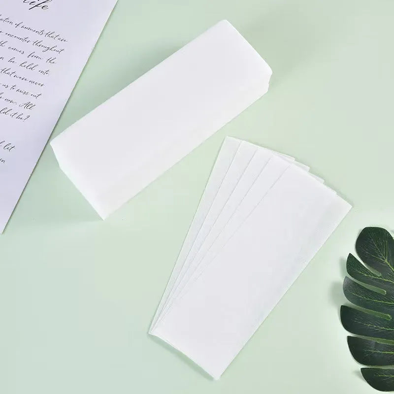 A pack of non-woven fabric hair removal wax paper auxiliary strips.