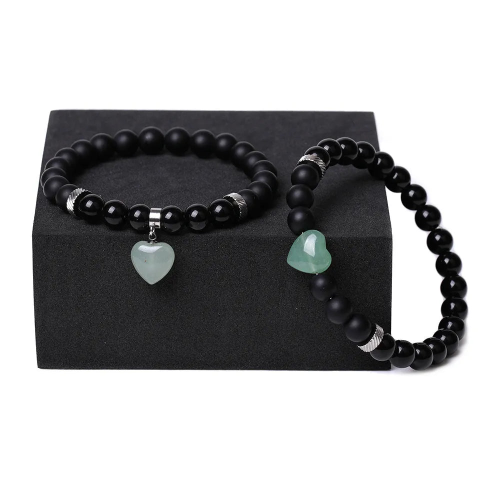 Matching couple bracelets with polished natural stone heart pendants in geometric style
