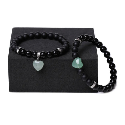 Matching couple bracelets with polished natural stone heart pendants in geometric style