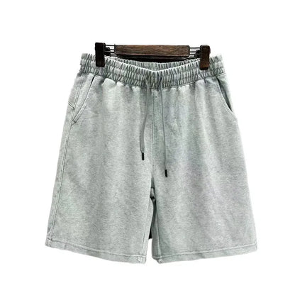 Men's distressed light blue cotton shorts with a loose straight-leg casual fit on a neutral background
