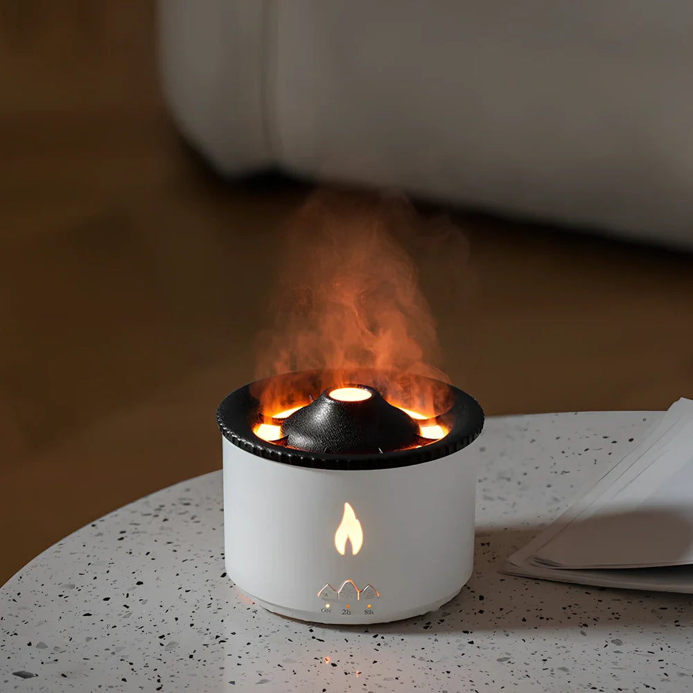 White volcano-shaped humidifier diffuser with flame lighting effect and remote control on wooden surface