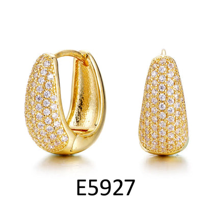 Gold plated heart-shaped clip earrings with a cluster of zircon stones, on a solid copper base.