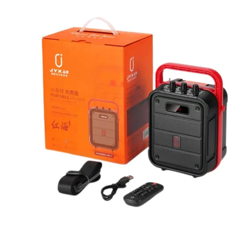MS62AI portable Bluetooth speaker with wireless microphone on a table, showing control knob and carry strap.