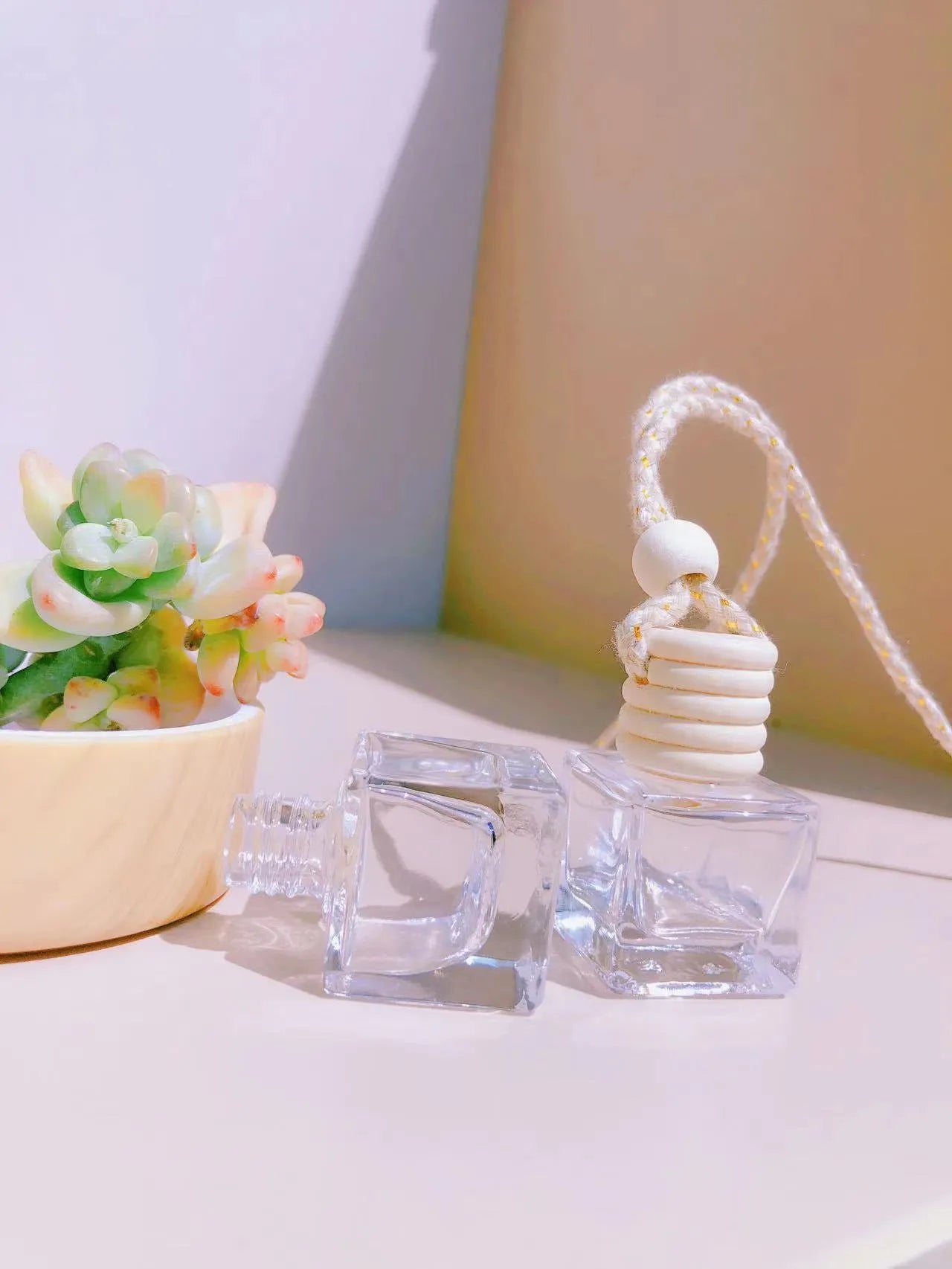 Car perfume pendant in four glass bottle styles: cylinder, diamond, flat drum, and square