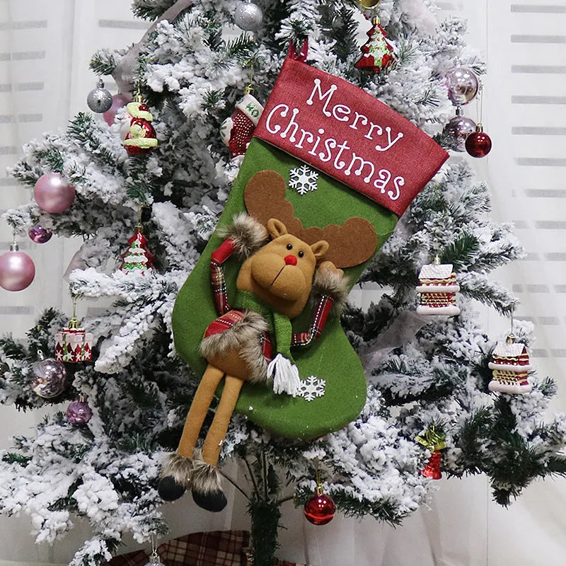 Set of three large red, white, and brown Christmas stockings with 3D Santa, Snowman, and Reindeer designs hanging on a tree.