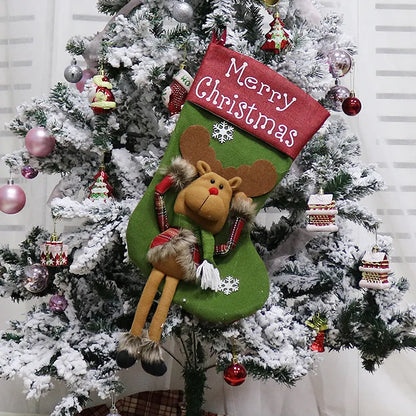 Set of three large red, white, and brown Christmas stockings with 3D Santa, Snowman, and Reindeer designs hanging on a tree.