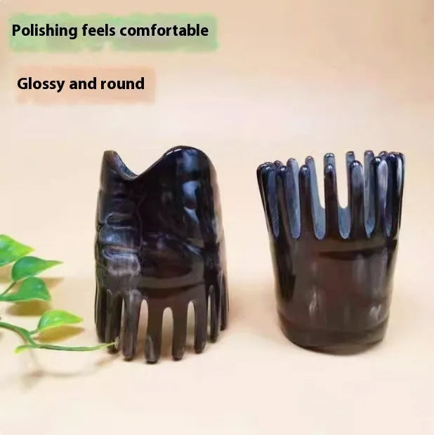 Black half-moon shaped buffalo horn comb with wide teeth for scalp massage and detangling hair.