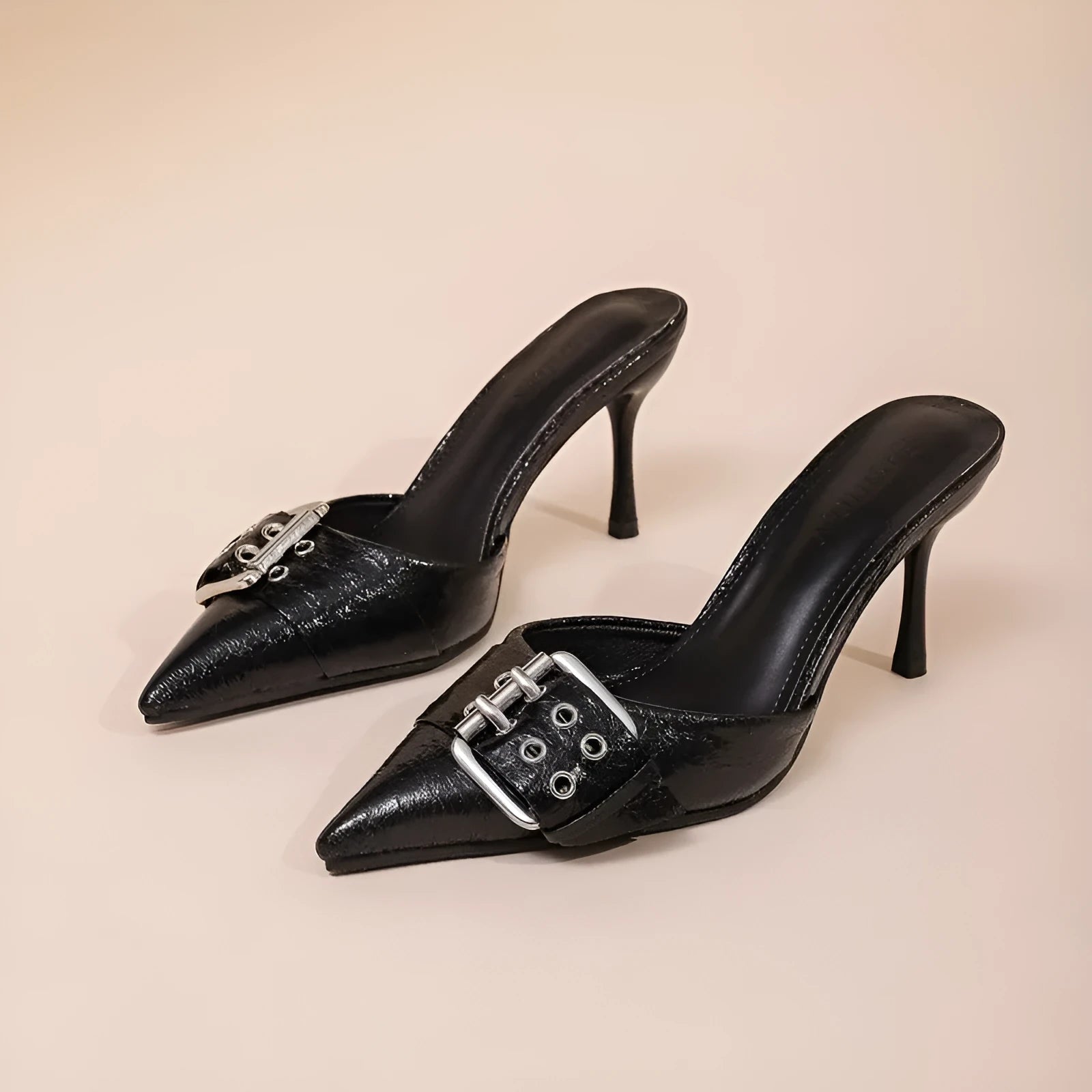 Black women's pointed toe high heel sandals with a decorative buckle on the front strap.