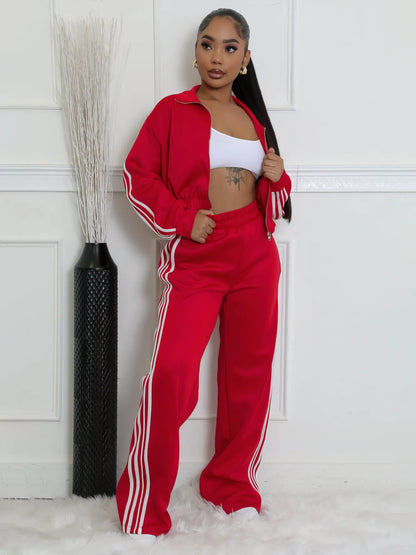 Grey striped streetwear two-piece suit set with zipper detailing on the top and trousers.