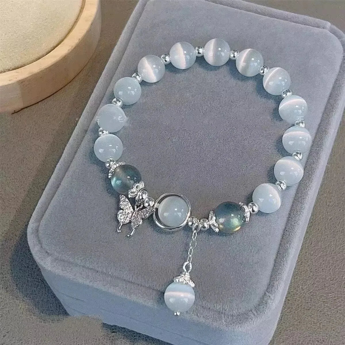 Handmade glass butterfly bracelet with drop-shaped beads in moonlight grey colour variation