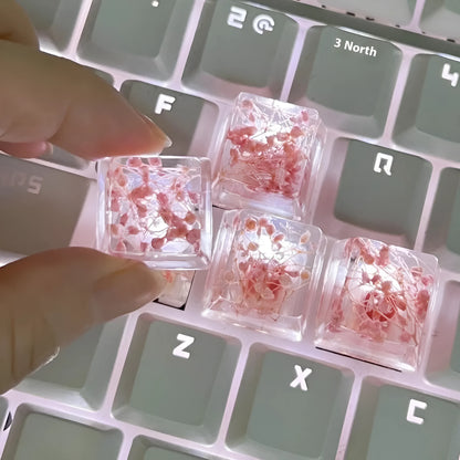 A transparent resin keycap with a starry sky design inside, shown in a green colour variant.